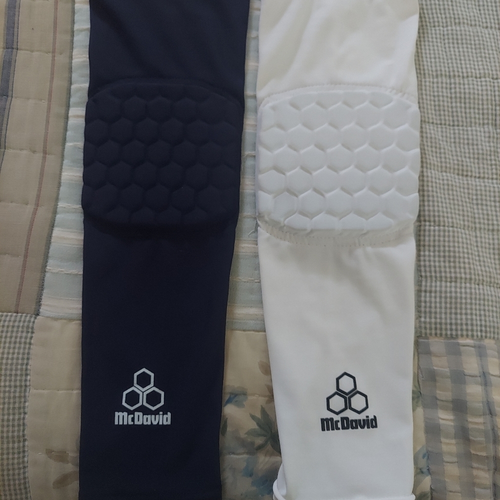 Two McDavid padded arm sleeves